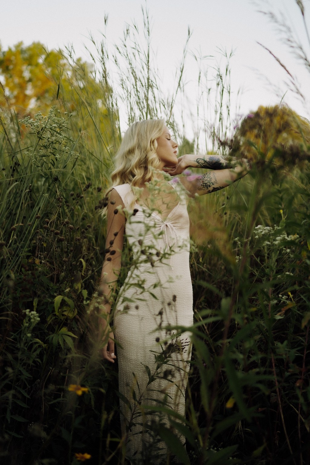 Portrait in a pale dress among garden flowers
