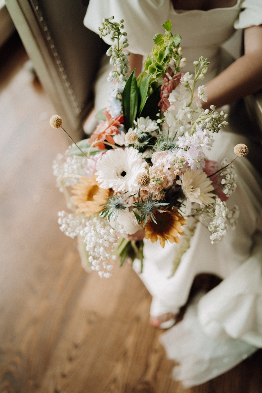 Colorful bridal bouquet with sunflowers and pastel blooms