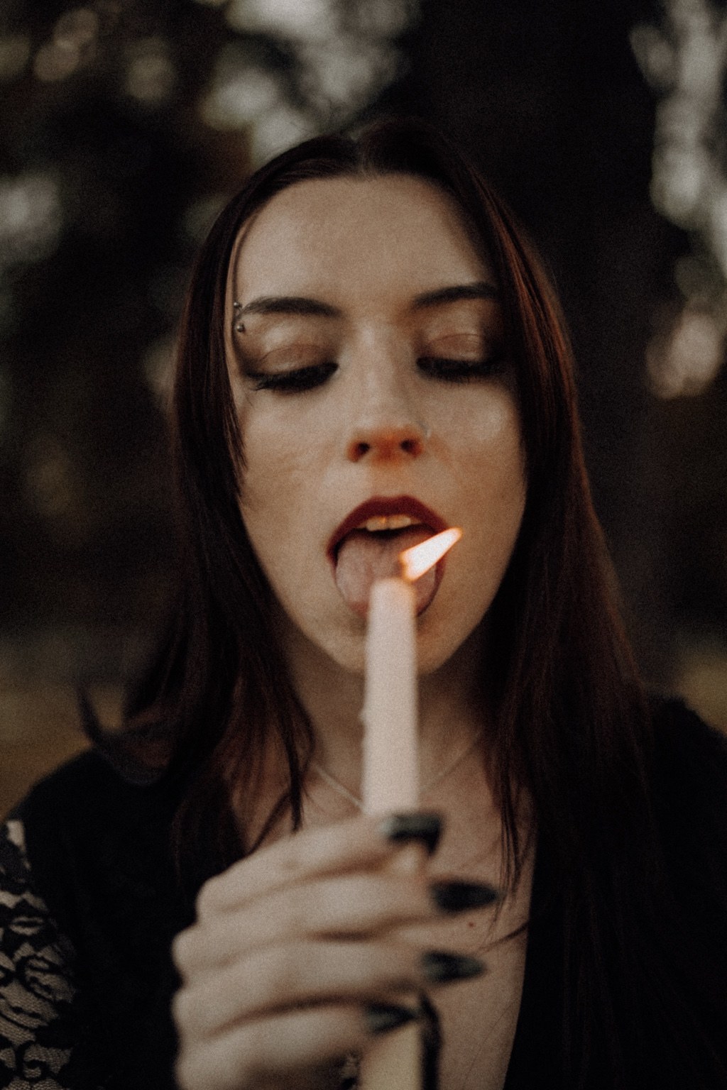 Close portrait with a candle flame