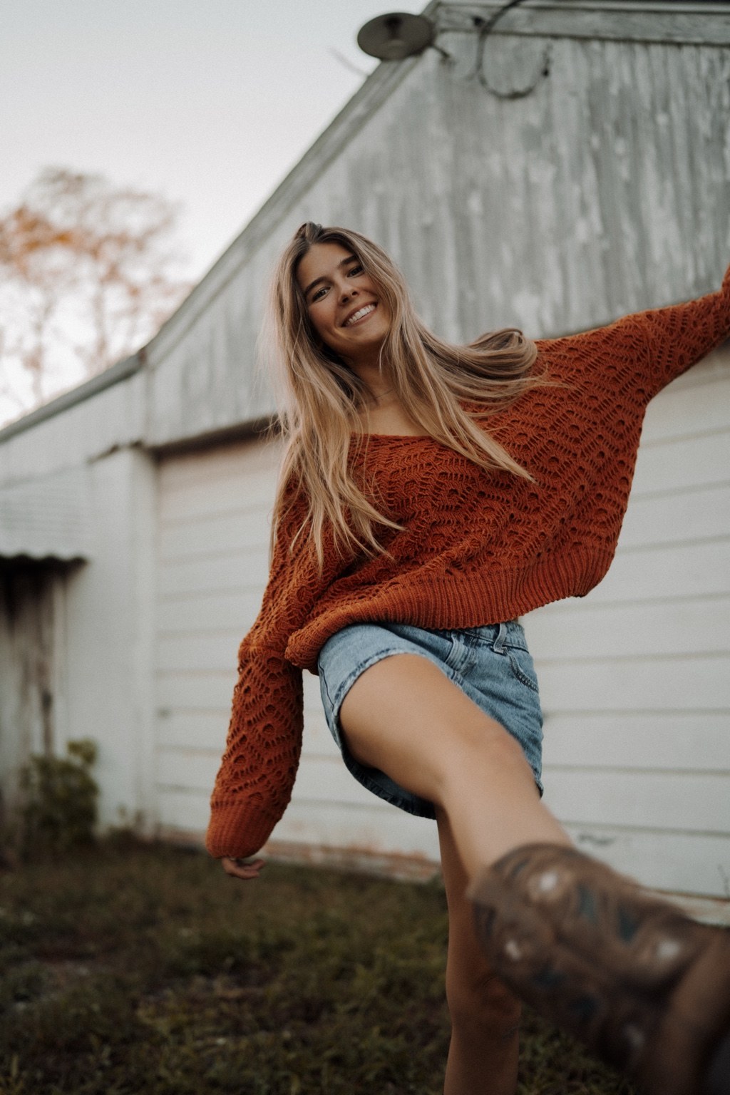 Relaxed seated portrait in a rust sweater